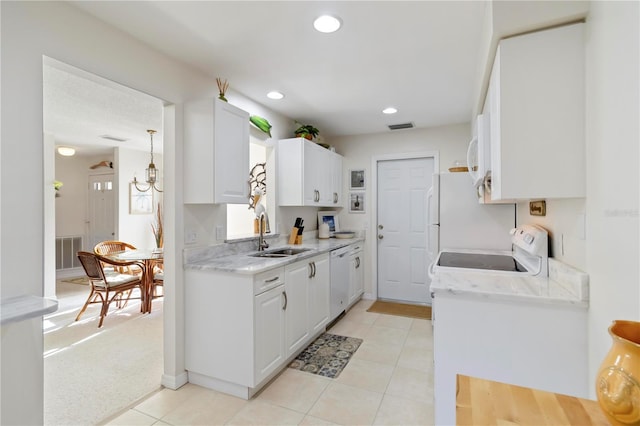 609 Deerwood Ave, Englewood, FL 34223 - kitchen featuring white appliances, white cabinets, light tile patterned floors, and recessed lighting