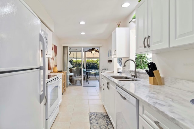 609 Deerwood Ave, Englewood, FL 34223 - kitchen featuring white appliances, recessed lighting, white cabinetry, light stone countertops, and light tile patterned floors