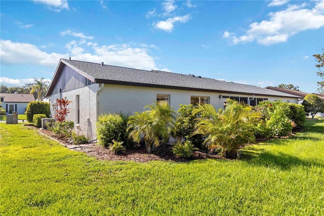 609 Deerwood Ave, Englewood, FL 34223 - view of property exterior with a yard and stucco siding