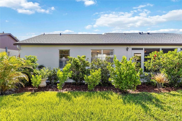 609 Deerwood Ave, Englewood, FL 34223 - back of house with stucco siding and roof with shingles