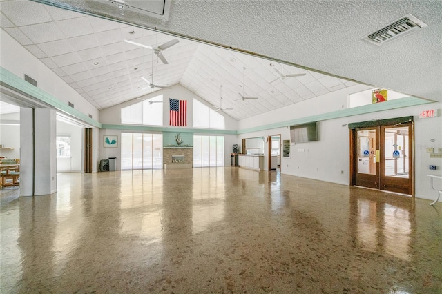 609 Deerwood Ave, Englewood, FL 34223 - interior space with high vaulted ceiling, ceiling fan, and a textured ceiling