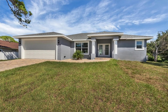 5781 Elton Rd, Venice, FL 34293 - view of front of property with french doors, stucco siding, a garage, and driveway