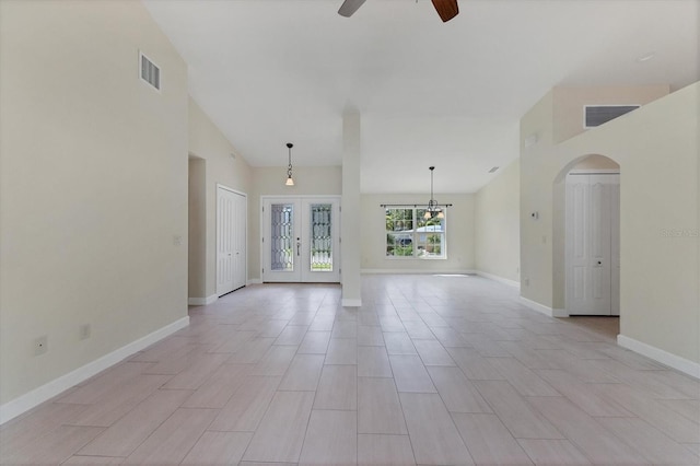 5781 Elton Rd, Venice, FL 34293 - unfurnished room featuring ceiling fan, arched walkways, french doors, high vaulted ceiling, and a chandelier