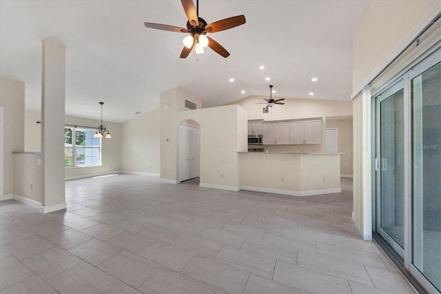 5781 Elton Rd, Venice, FL 34293 - unfurnished living room featuring a ceiling fan, vaulted ceiling, recessed lighting, arched walkways, and a chandelier