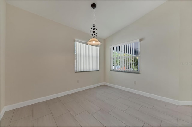 5781 Elton Rd, Venice, FL 34293 - spare room featuring vaulted ceiling and baseboards