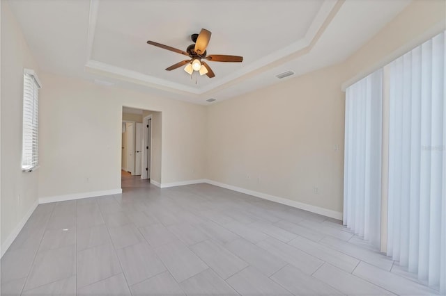 5781 Elton Rd, Venice, FL 34293 - unfurnished room with a tray ceiling, a ceiling fan, and plenty of natural light