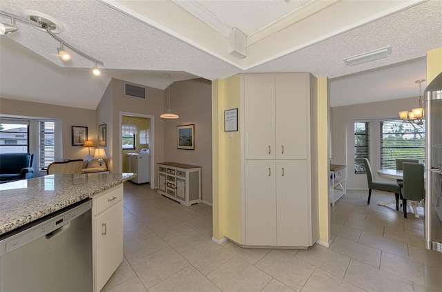 7218 Darlington St, Englewood, FL 34224 - kitchen with stainless steel dishwasher, light tile patterned floors, a chandelier, healthy amount of natural light, and vaulted ceiling