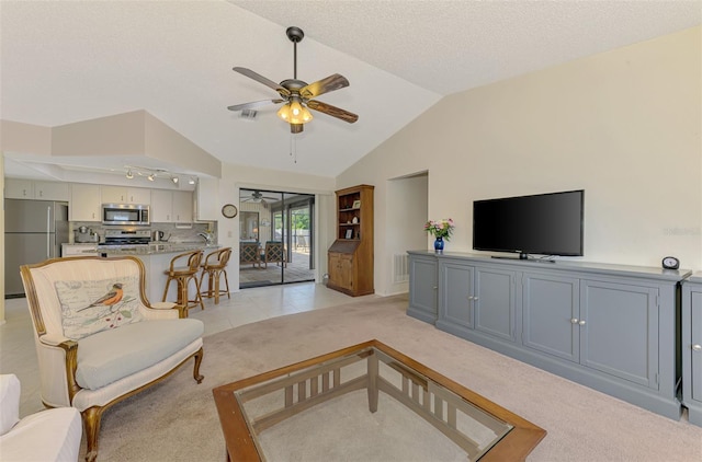 7218 Darlington St, Englewood, FL 34224 - living room with ceiling fan, light colored carpet, lofted ceiling, and a textured ceiling
