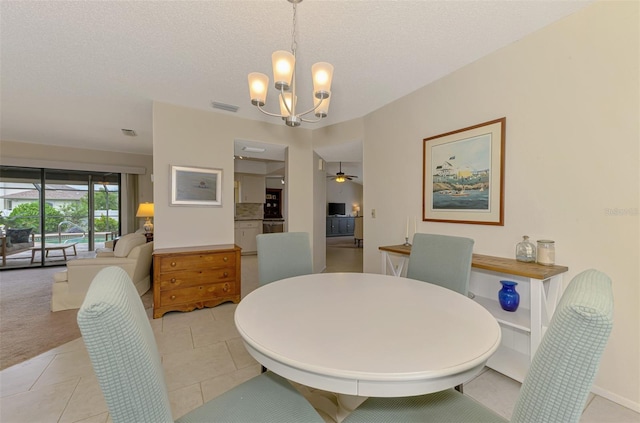 7218 Darlington St, Englewood, FL 34224 - dining room featuring a chandelier, a textured ceiling, and light tile patterned floors