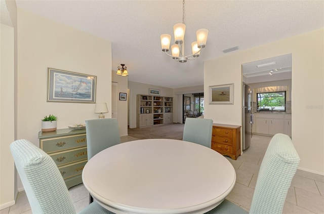 7218 Darlington St, Englewood, FL 34224 - dining area with a chandelier, light tile patterned floors, and a textured ceiling