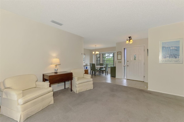 7218 Darlington St, Englewood, FL 34224 - living area featuring light carpet, a chandelier, and a textured ceiling