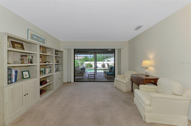7218 Darlington St, Englewood, FL 34224 - sitting room featuring light colored carpet and a textured ceiling