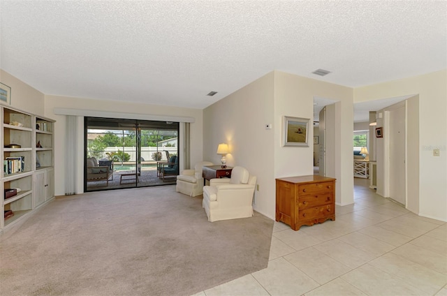 7218 Darlington St, Englewood, FL 34224 - sitting room with a textured ceiling, light tile patterned flooring, and light colored carpet