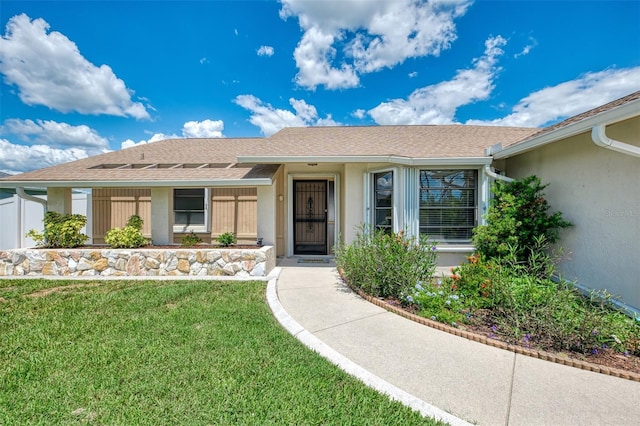 7218 Darlington St, Englewood, FL 34224 - ranch-style home featuring a front yard, stucco siding, and roof with shingles