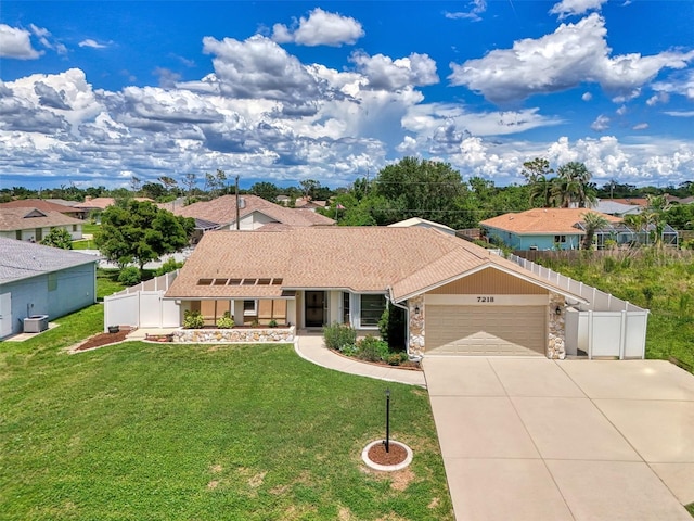 7218 Darlington St, Englewood, FL 34224 - view of front of house with a garage, concrete driveway, stone siding, and a residential view