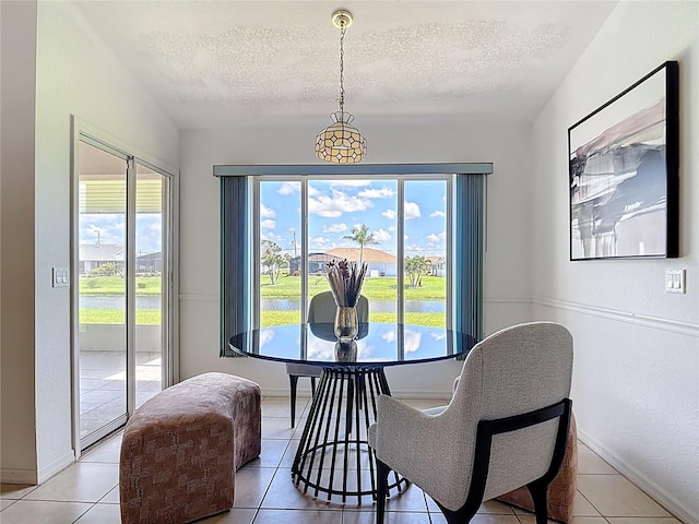 104 Mark Twain Ln, Rotonda West, FL 33947 - dining room with a textured ceiling, plenty of natural light, and light tile patterned floors