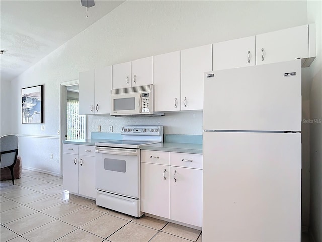 104 Mark Twain Ln, Rotonda West, FL 33947 - kitchen with white appliances, lofted ceiling, and white cabinetry