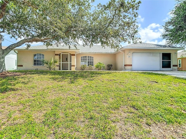 104 Mark Twain Ln, Rotonda West, FL 33947 - ranch-style home featuring stucco siding, a garage, and a front yard