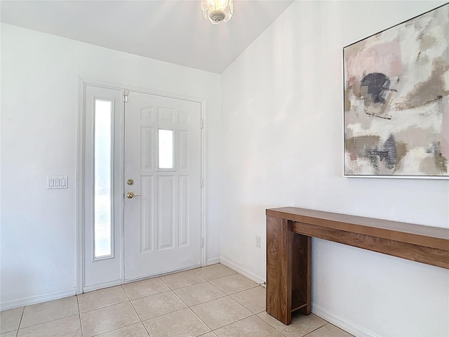 104 Mark Twain Ln, Rotonda West, FL 33947 - foyer entrance with light tile patterned flooring and baseboards