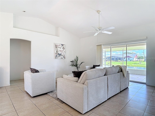 104 Mark Twain Ln, Rotonda West, FL 33947 - living room featuring light tile patterned flooring, a ceiling fan, arched walkways, and high vaulted ceiling