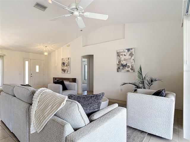 104 Mark Twain Ln, Rotonda West, FL 33947 - living area with arched walkways, light tile patterned floors, ceiling fan, and high vaulted ceiling