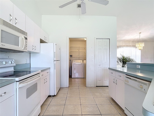 104 Mark Twain Ln, Rotonda West, FL 33947 - kitchen featuring white appliances, independent washer and dryer, light tile patterned flooring, white cabinetry, and a ceiling fan
