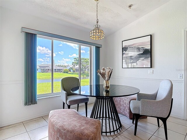 104 Mark Twain Ln, Rotonda West, FL 33947 - dining room featuring a textured ceiling, plenty of natural light, and light tile patterned floors