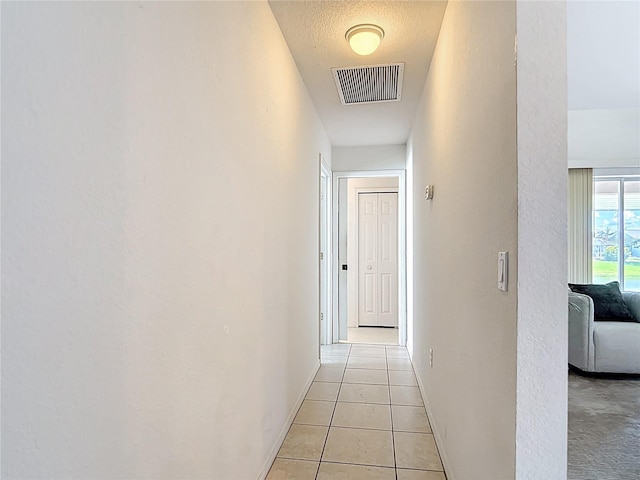 104 Mark Twain Ln, Rotonda West, FL 33947 - corridor with light tile patterned floors and baseboards