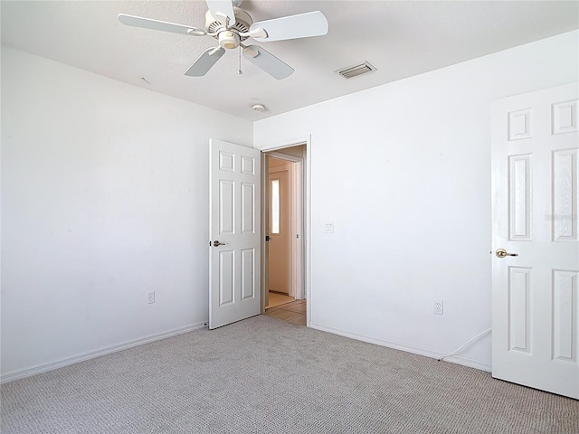 104 Mark Twain Ln, Rotonda West, FL 33947 - unfurnished room with light carpet and ceiling fan