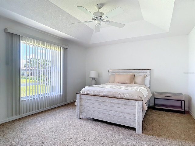 104 Mark Twain Ln, Rotonda West, FL 33947 - carpeted bedroom with a ceiling fan and a tray ceiling