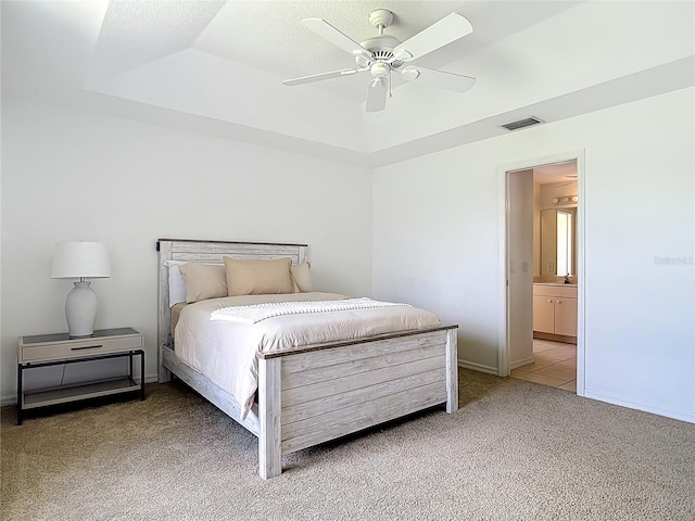 104 Mark Twain Ln, Rotonda West, FL 33947 - bedroom featuring light colored carpet, a tray ceiling, and ceiling fan