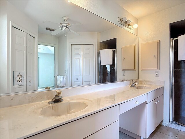 104 Mark Twain Ln, Rotonda West, FL 33947 - bathroom with double vanity, ceiling fan, a shower stall, and tile patterned floors