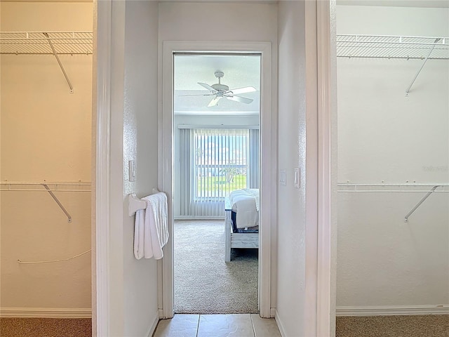 104 Mark Twain Ln, Rotonda West, FL 33947 - corridor with light colored carpet and light tile patterned floors
