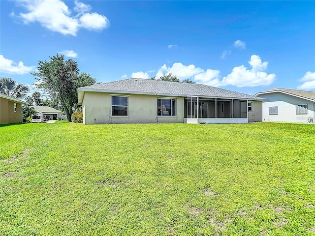 104 Mark Twain Ln, Rotonda West, FL 33947 - back of house with a yard, a sunroom, and stucco siding