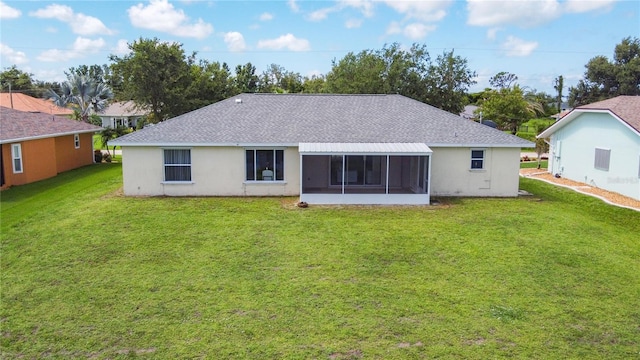 104 Mark Twain Ln, Rotonda West, FL 33947 - rear view of house featuring a shingled roof, a lawn, a sunroom, and stucco siding