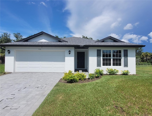 7168 Rison St, Port Charlotte, FL 33981 - single story home with stucco siding, decorative driveway, and a front yard