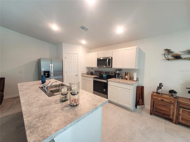 7168 Rison St, Port Charlotte, FL 33981 - kitchen featuring appliances with stainless steel finishes, white cabinets, light countertops, recessed lighting, and a center island with sink