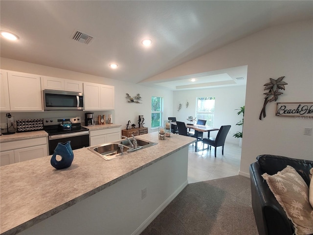 7168 Rison St, Port Charlotte, FL 33981 - kitchen with appliances with stainless steel finishes, white cabinetry, recessed lighting, vaulted ceiling, and light countertops