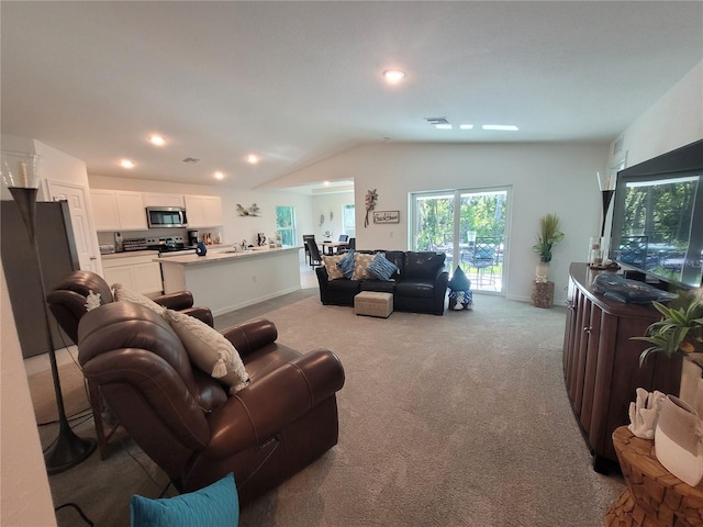 7168 Rison St, Port Charlotte, FL 33981 - carpeted living room featuring vaulted ceiling and recessed lighting