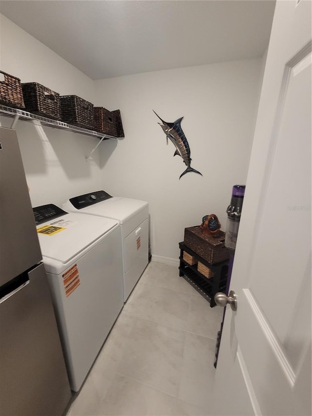 7168 Rison St, Port Charlotte, FL 33981 - laundry room featuring washer and dryer and light tile patterned floors