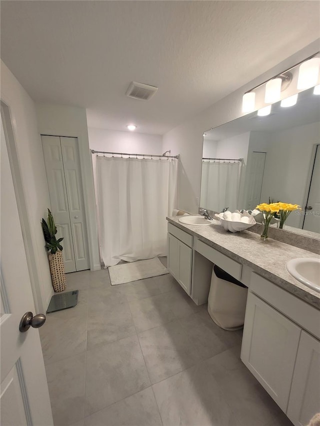 7168 Rison St, Port Charlotte, FL 33981 - full bathroom featuring double vanity, curtained shower, and tile patterned floors