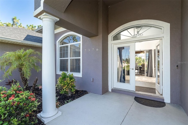 7376 Stetson Ln, Port Charlotte, FL 33981 - view of exterior entry with stucco siding and a patio