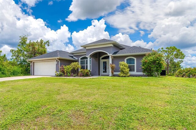 7376 Stetson Ln, Port Charlotte, FL 33981 - view of front of home featuring a garage, concrete driveway, stucco siding, and a front lawn