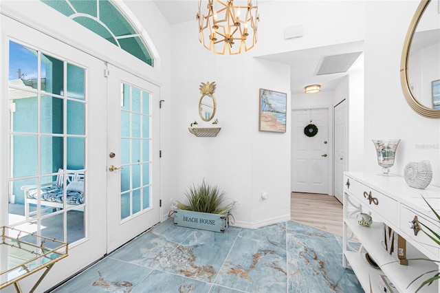 926 Boundary Blvd, Rotonda West, FL 33947 - entryway with french doors and a chandelier