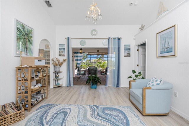 926 Boundary Blvd, Rotonda West, FL 33947 - sitting room with wood finished floors, a chandelier, and arched walkways