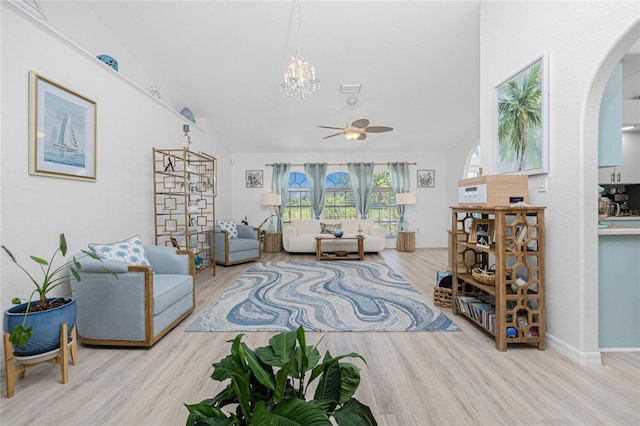 926 Boundary Blvd, Rotonda West, FL 33947 - living area featuring arched walkways, a ceiling fan, wood finished floors, and a chandelier
