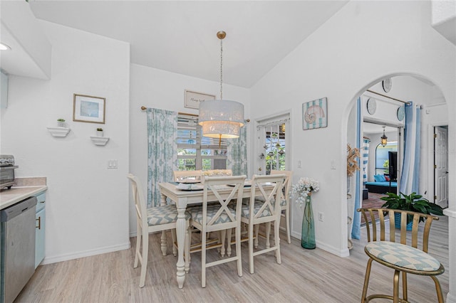 926 Boundary Blvd, Rotonda West, FL 33947 - dining space featuring light wood-style floors, arched walkways, and vaulted ceiling