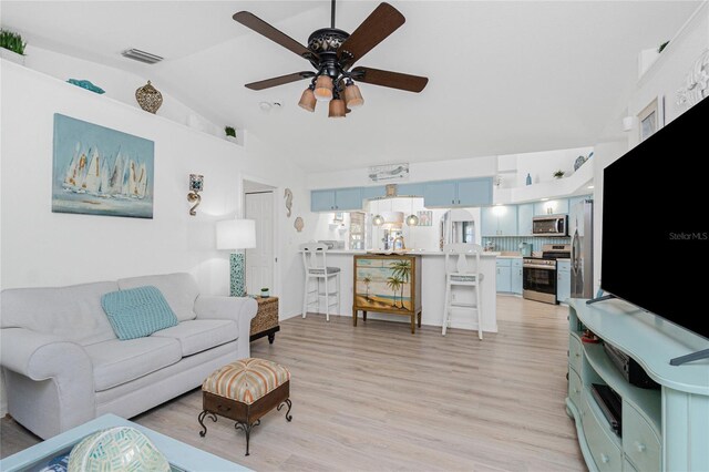 926 Boundary Blvd, Rotonda West, FL 33947 - living room featuring lofted ceiling, a ceiling fan, and light wood finished floors