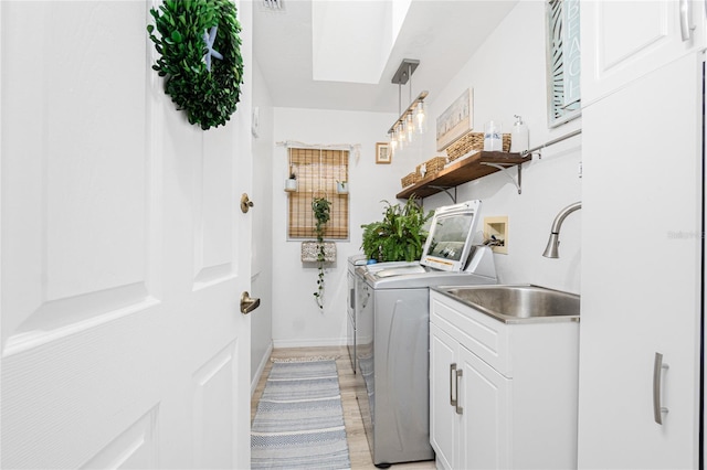 926 Boundary Blvd, Rotonda West, FL 33947 - laundry area featuring separate washer and dryer, a skylight, and light wood-style flooring