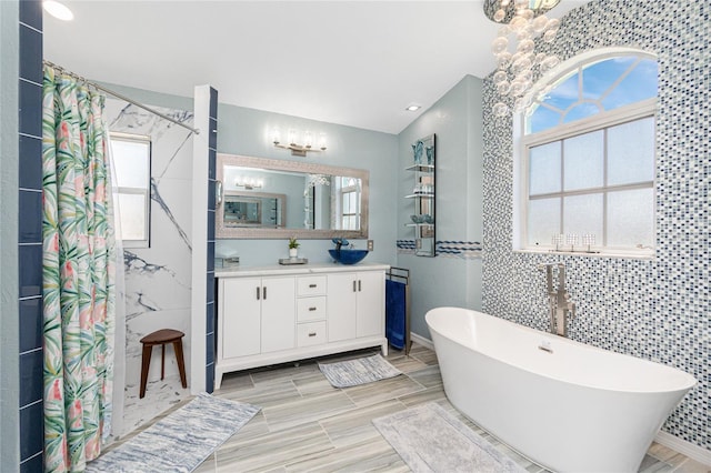 926 Boundary Blvd, Rotonda West, FL 33947 - full bathroom with a chandelier, vanity, a shower with curtain, a soaking tub, and vaulted ceiling